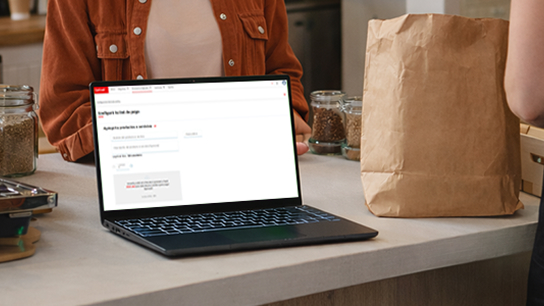 Notebook sobre un mostrador con la pantalla del Getnet Portal abierta, junto a frascos y una bolsa de papel.