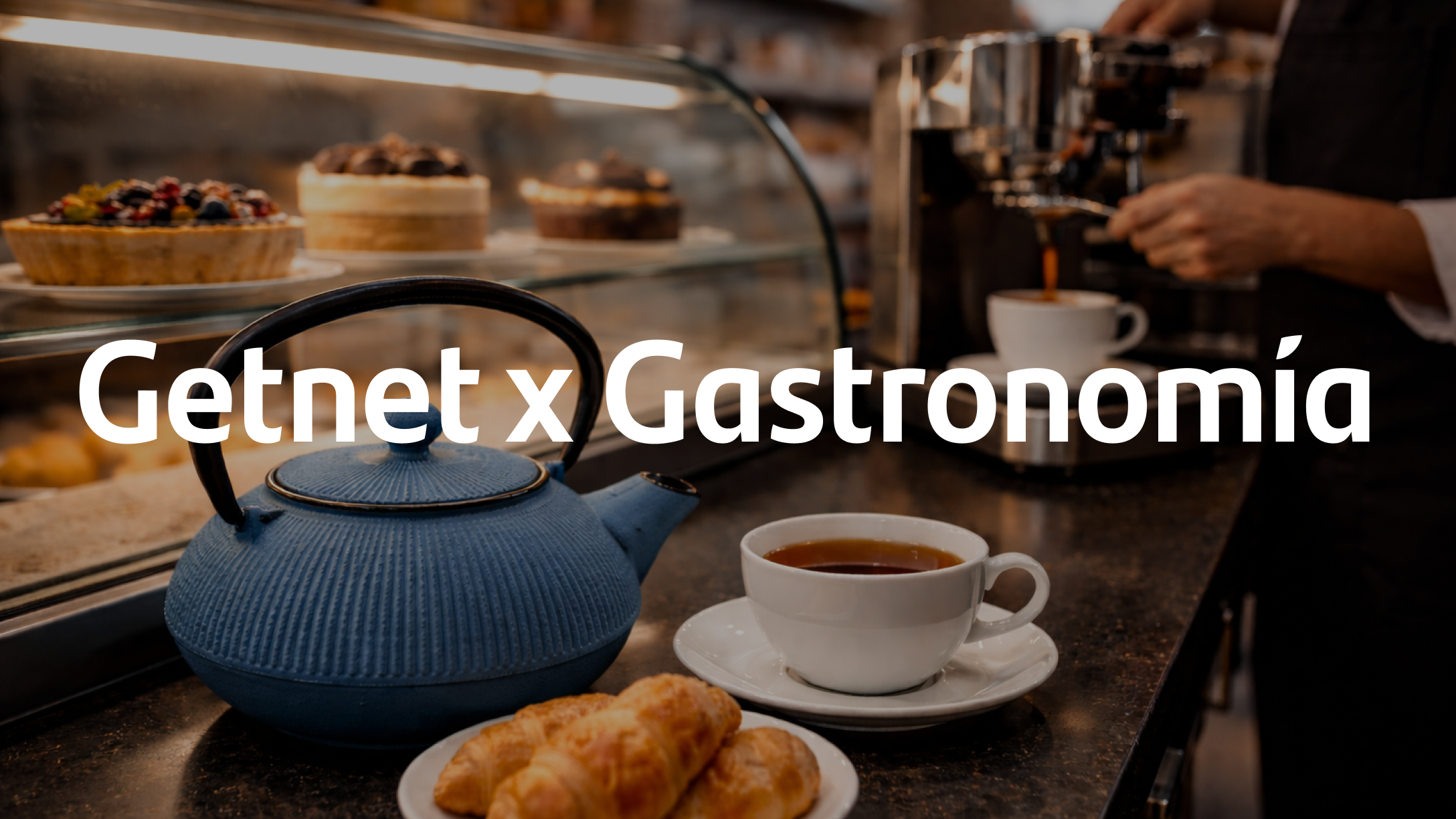 Tetera, taza de café y medialunas en una barra de cafetería con una máquina de café al fondo y el texto ‘Getnet x Gastronomía’.